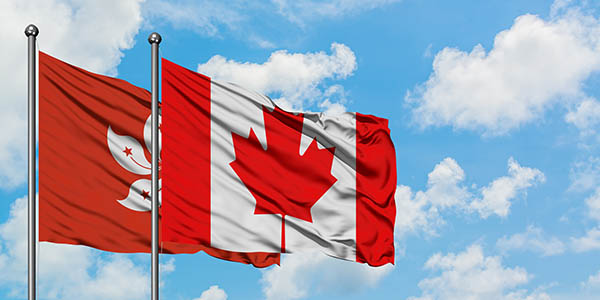 Hong Kong and Canada flag waving in the wind against white cloud